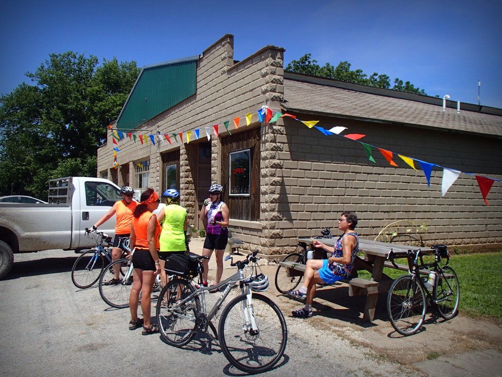 Bicyclists take a break at the Mildred Store in Mildred, Kansas.
